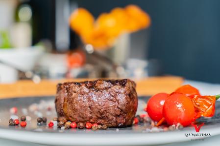 Prepared and garnished steak at Steakhouse Las Malvinas 